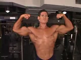 Champ Jason posing at the gym