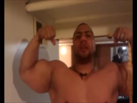 Shows off huge biceps
