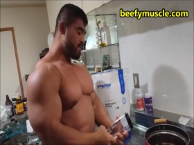 Making protein shake for his massive pecs