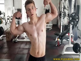 Young stud pumps Chest and Biceps in the gym