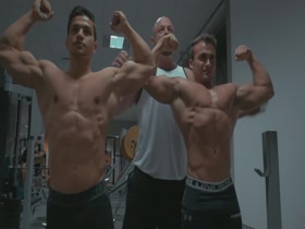 Young Bodybuilders flexing for their coach