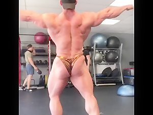 Bodybuilder posing trunks glutes