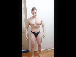 Young alpha natural bodybuilder flexing