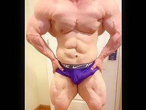 The giant Elliot Dermond posing with a boner in his shorts
