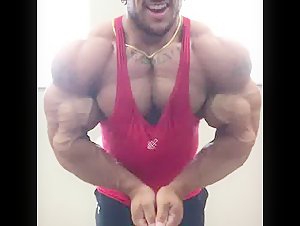 massive beast in a red tank, flexing for the pleasure of flexing