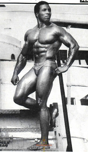 Leon Brown posing on metal stairs at a shipping yard