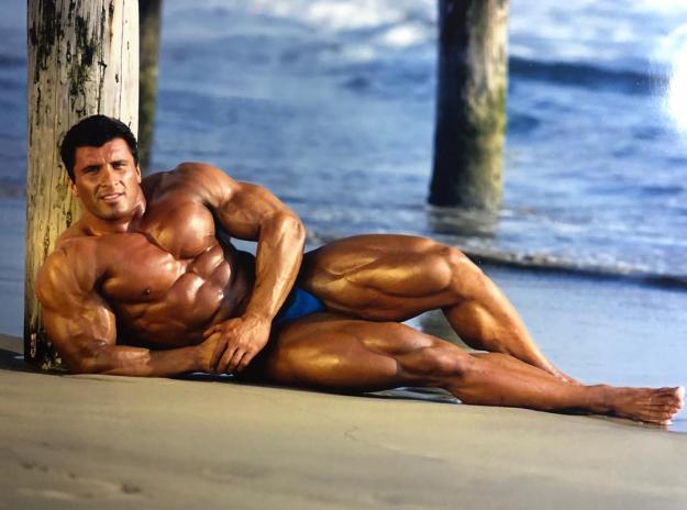 Bodybuilder posing at the beach