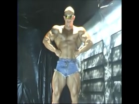 Colossal muscle man flexing and jerking off with uncut dick