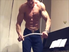 Russian bodybuilder Misha bending a iron bar