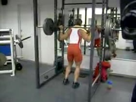 Latin athlete Jorge squatting