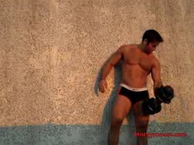 Muscle jock working out and stripping down