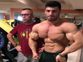 BIG MALE BODYBUILDER WORKING OUT & FLEXING.