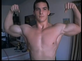 Massive biceps on hot young bodybuilder