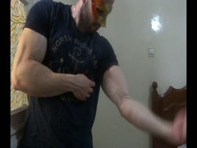 Ripped Muscle Stud flexing while wearing a mask