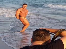 Bodybuilder on the beach (short)
