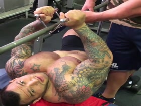 hot muscle tattooed at gym