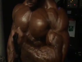Black Muscle God doing a pre-contest pump up - bigger and bigger