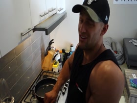 Muscular guy cooking naked