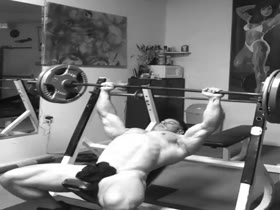 Naked bodybuilder working out