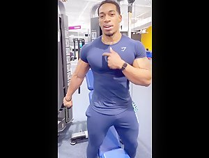 Hot bodybuilder pumps pecs in tight spandex lycra shirt