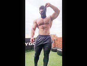 Hairy pumped muscle guy showing off