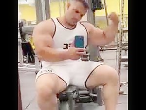 thick muscled powerlifter flexing huge bicep