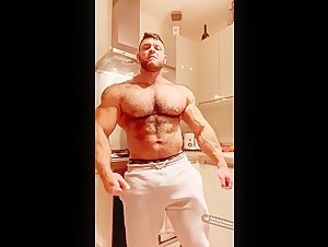 Cocky huge bodybuilder with sweatpants bulge