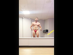 Muscle teen bodybuilder on red posing trunks