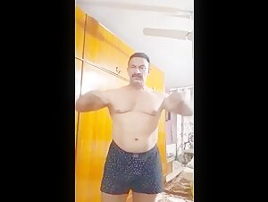 Pakistani men flex muscle