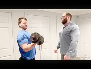 Muscled buddies comparing biceps