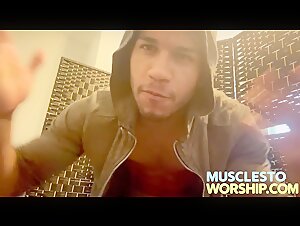 Troy shows off shredded abs and huge biceps,