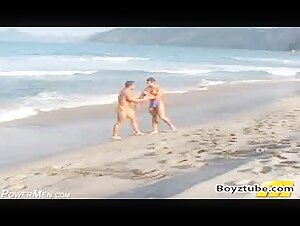 Bodybuilder beach wrestling in thong